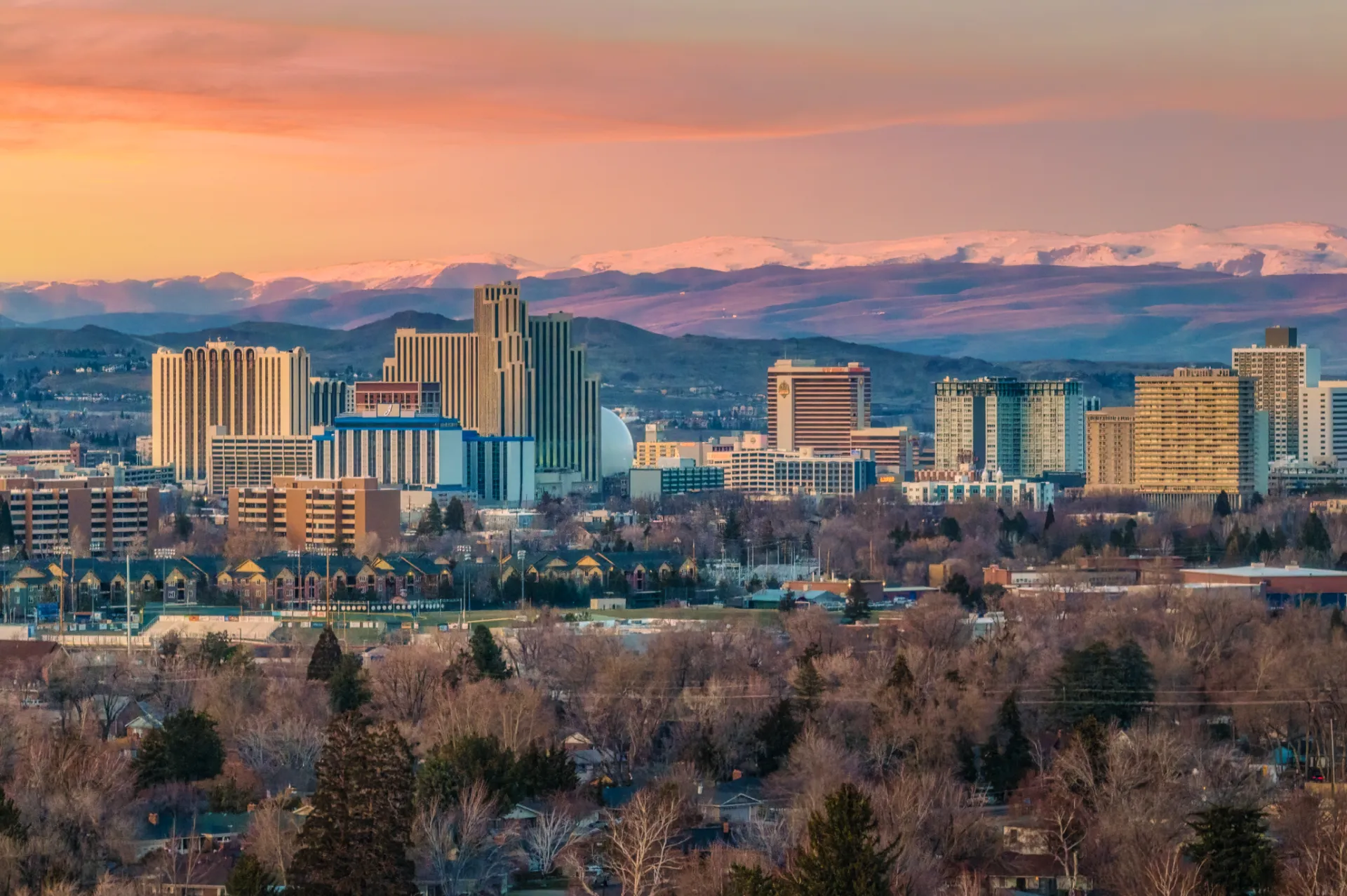 Downtown Reno skyline at sunrise with the Sierra Nevada behind