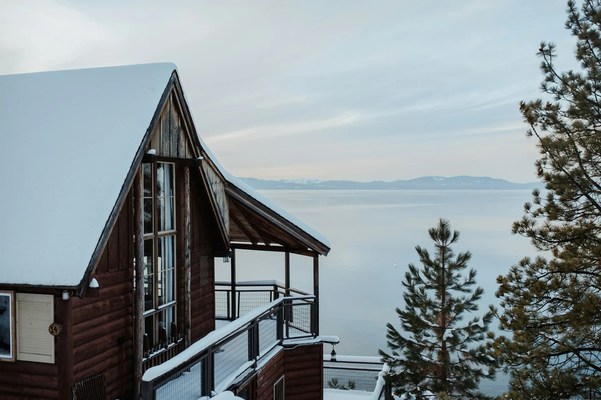 A-frame chalet overlooking a misty Tahoe lake in winter